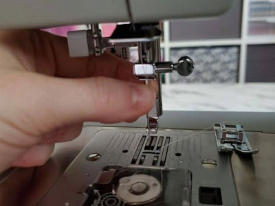 quitar la aguja y el prensatelas de una máquina de coser